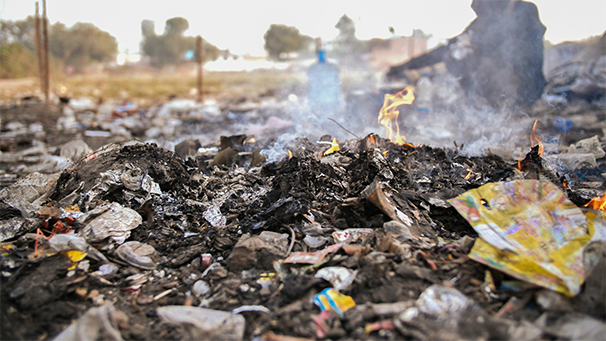 Burned waste remains spread over a large area of land
